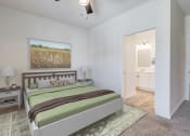 Thumbnail 16 of 65 - a bedroom with a bed and a bathroom with a closet
