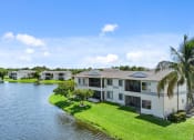 Thumbnail 7 of 41 - a group of houses next to a body of water