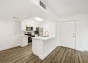 Thumbnail 27 of 42 - a white kitchen with a white counter top and