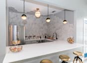 Thumbnail 4 of 31 - a kitchen with a long counter top and a refrigerator