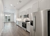 Thumbnail 49 of 57 - A modern kitchen with stainless steel appliances and white cabinets.