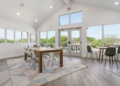 Thumbnail 13 of 29 - a dining room with a table and chairs and windows