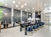 Thumbnail 25 of 34 - A modern dining room with a long table set for a meal.