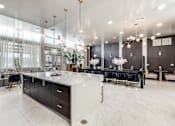 Thumbnail 23 of 34 - A modern kitchen with a large island and a dining area.