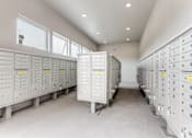 Thumbnail 28 of 34 - A row of white electrical boxes with yellow labels are lined up in a room.