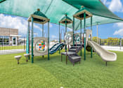 Thumbnail 29 of 34 - A playground with a green slide and a green canopy.