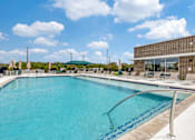 Thumbnail 19 of 34 - A large swimming pool with a metal ladder in the middle.