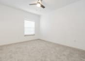 Thumbnail 37 of 41 - an empty room with a ceiling fan and a window