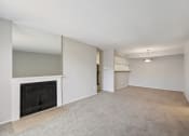 Thumbnail 13 of 34 - the living room and dining room of an empty home with a fireplace