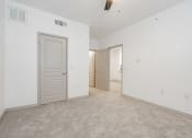 Thumbnail 15 of 41 - a bedroom with white walls and carpet and a door to a closet