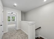 Thumbnail 45 of 56 - A room with white walls and a carpeted floor.
