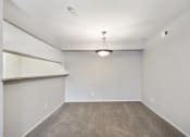 Thumbnail 14 of 34 - an empty room with carpet and a light hanging from the ceiling