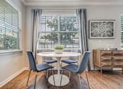 Thumbnail 3 of 30 - A dining room with a table and chairs.