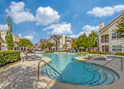 Thumbnail 24 of 30 - A swimming pool surrounded by a residential area.