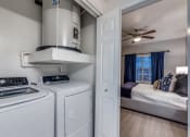 Thumbnail 16 of 37 - the washer and dryer in the laundry room of a home with a bedroom