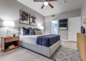 Thumbnail 15 of 37 - a bedroom with a bed and a ceiling fan