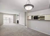 Thumbnail 10 of 34 - the living room and kitchen of an empty apartment with a microwave and refrigerator