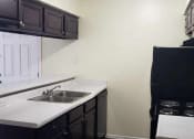 Thumbnail 2 of 8 - a kitchen with a sink and a refrigerator