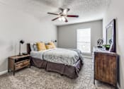 Thumbnail 15 of 27 - the master bedroom has a king sized bed and a ceiling fan