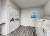 Thumbnail 23 of 27 - a kitchen with white cabinets and appliances and a counter