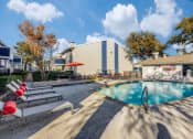 Thumbnail 14 of 20 - our apartments have a resort style pool and lounge chairs