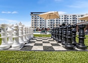 Thumbnail 16 of 31 - Giant chess pieces on a grassy field.