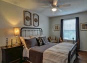 Thumbnail 7 of 8 - a bedroom with a bed and a ceiling fan