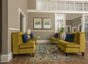 Thumbnail 27 of 32 - a living room with yellow couches and a blue rug