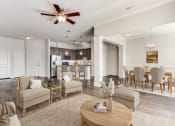 Thumbnail 4 of 42 - a living room with a dining room and a kitchen