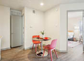 Thumbnail 6 of 40 - A small dining room with a table and chairs.