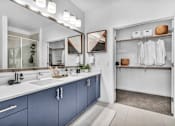 Thumbnail 15 of 33 - a blue and white bathroom with two sinks and a mirror