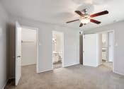 Thumbnail 6 of 34 - an empty room with mirrored doors and a ceiling fan