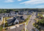 Thumbnail 40 of 47 - A large, well-maintained residential complex with multiple buildings and a spacious parking lot.