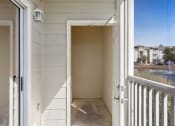 Thumbnail 15 of 30 - A white door is open to a balcony.