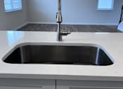 Thumbnail 26 of 32 - A modern kitchen with a stainless steel sink and white cabinets.