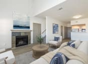 Thumbnail 4 of 23 - a living room with a fireplace and a couch