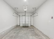 Thumbnail 54 of 56 - A large empty room with a concrete floor and white walls.