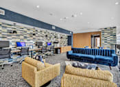 Thumbnail 28 of 33 - an airport lounge with chairs and tables and a purple ceiling