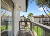Thumbnail 9 of 34 - a view from the balcony of a house with a yard and a tree