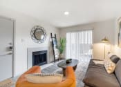 Thumbnail 1 of 27 - a living room with a couch and a fireplace