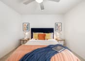 Thumbnail 6 of 27 - a bedroom with a large bed and a ceiling fan