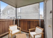 Thumbnail 9 of 27 - two chairs and a table on a balcony with a sliding glass door