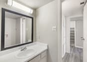 Thumbnail 17 of 27 - a bathroom with two sinks and a mirror and a closet