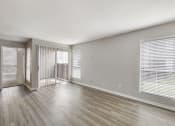 Thumbnail 10 of 27 - the living room of an apartment with wood flooring and a balcony