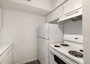 Thumbnail 13 of 27 - a kitchen with white appliances and a refrigerator