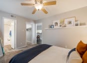 Thumbnail 7 of 20 - a bedroom with a large bed and a ceiling fan