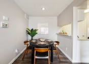 Thumbnail 3 of 20 - a dining room with a table and chairs