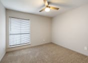 Thumbnail 16 of 20 - an empty room with a large window and a ceiling fan