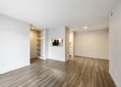 Thumbnail 11 of 20 - a living room with white walls and a wooden floor