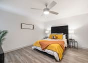 Thumbnail 18 of 37 - a bedroom with a bed and a ceiling fan
